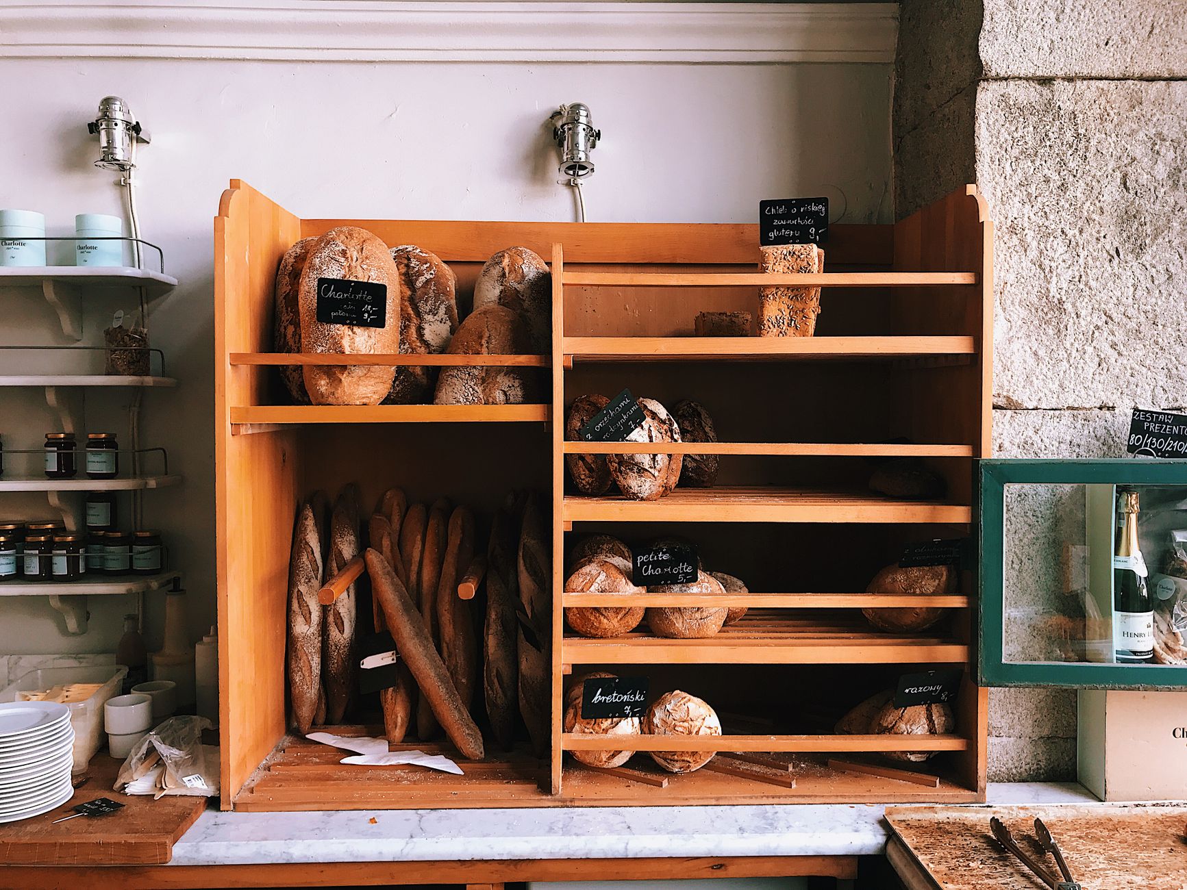 Warm beleuchtete Bäckerei mit frischen Broten auf Holzregalen